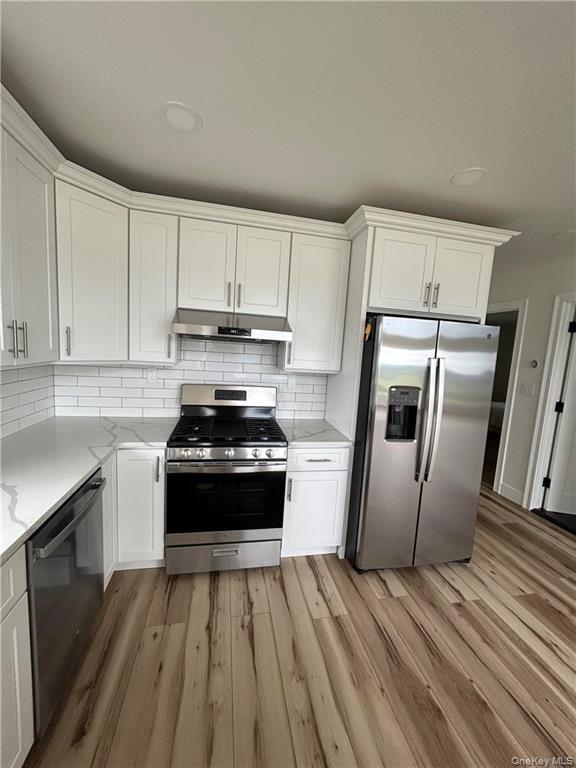 274 Reservoir Hill Road Norwich, NY 13815 - Photo 9 of 44 a kitchen with a sink a refrigerator and cabinets