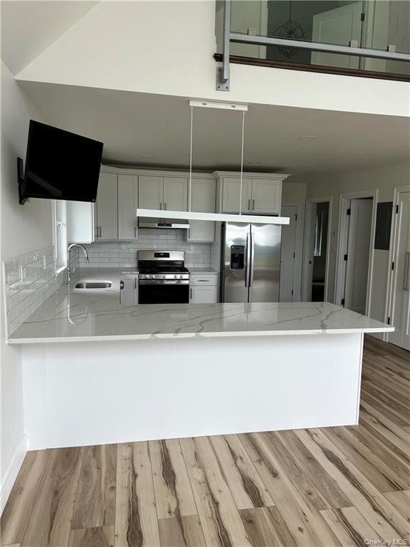 274 Reservoir Hill Road Norwich, NY 13815 - Photo 10 of 44 a living room with furniture and a flat screen tv