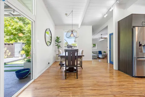 a living room with furniture fireplace and potted plants