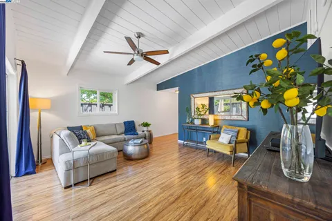 a spacious bedroom with a large bed and a chandelier