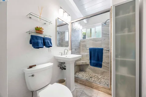 a bedroom with a bed and painting on the wall