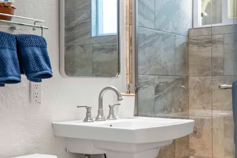 a bathroom with a sink mirror toilet and shower