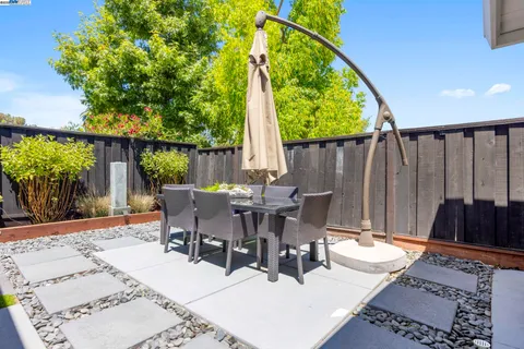 a swimming pool with outdoor seating and yard