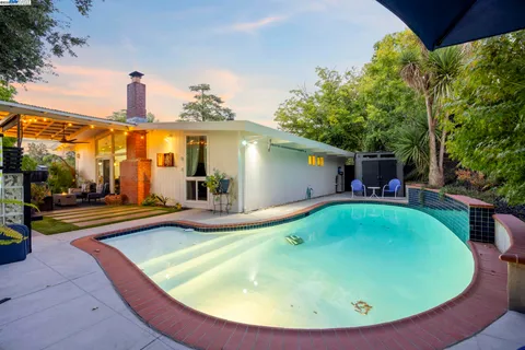 a view of a field of grass and trees
