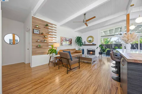 a living room with fireplace furniture and a wooden floor