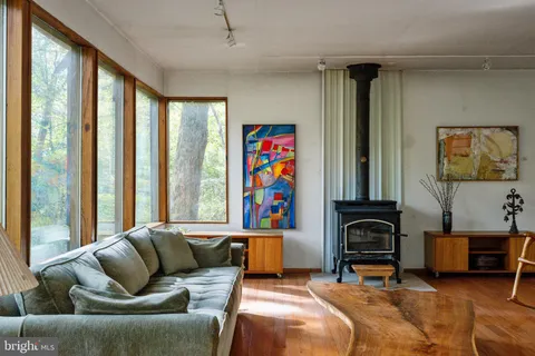a view of a workspace with furniture and book shelf