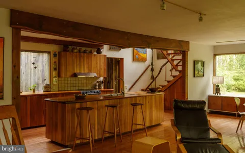 a view of a living room with a floor to ceiling window and floor to ceiling window