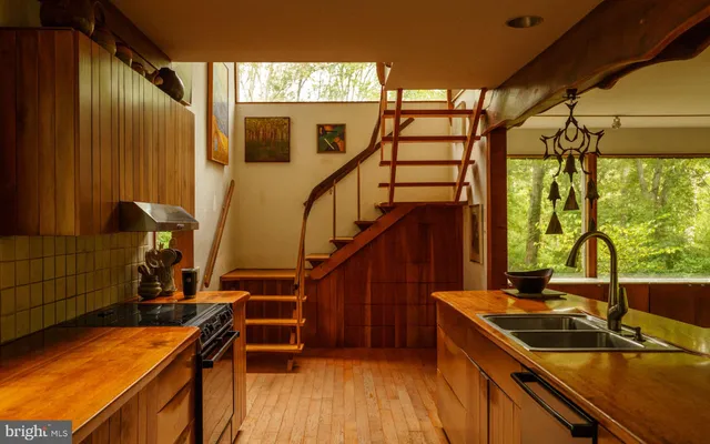 a view of a livingroom with furniture and staircase