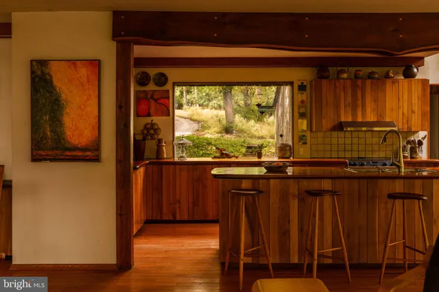 a living room with furniture and a book shelf