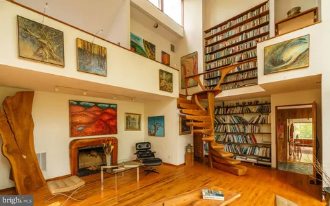 a bedroom with a bed and a wall painting