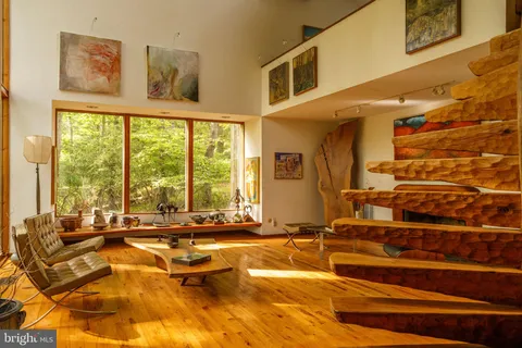 a living room with large window and furniture