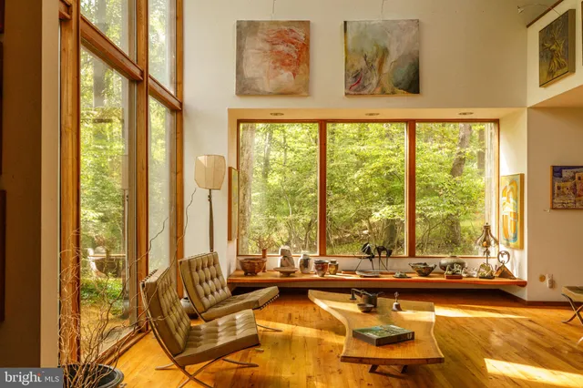 a large room with a large window and furniture