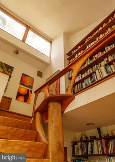 a view of a room with wooden floor and a window