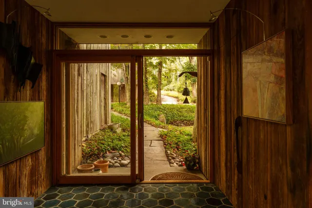 a living room with furniture and floor to ceiling windows