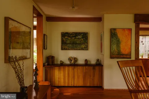 a dining room with furniture and wooden floor