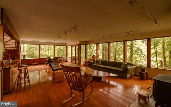 a living room with furniture a fireplace and a large window