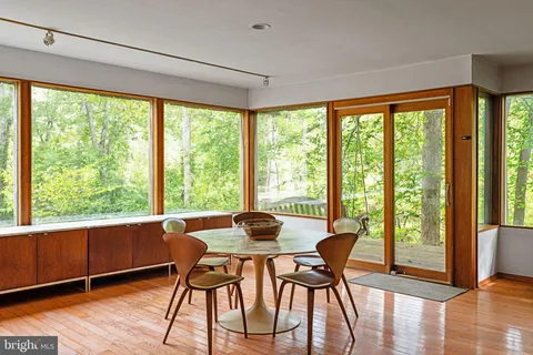 a living room with furniture and floor to ceiling windows