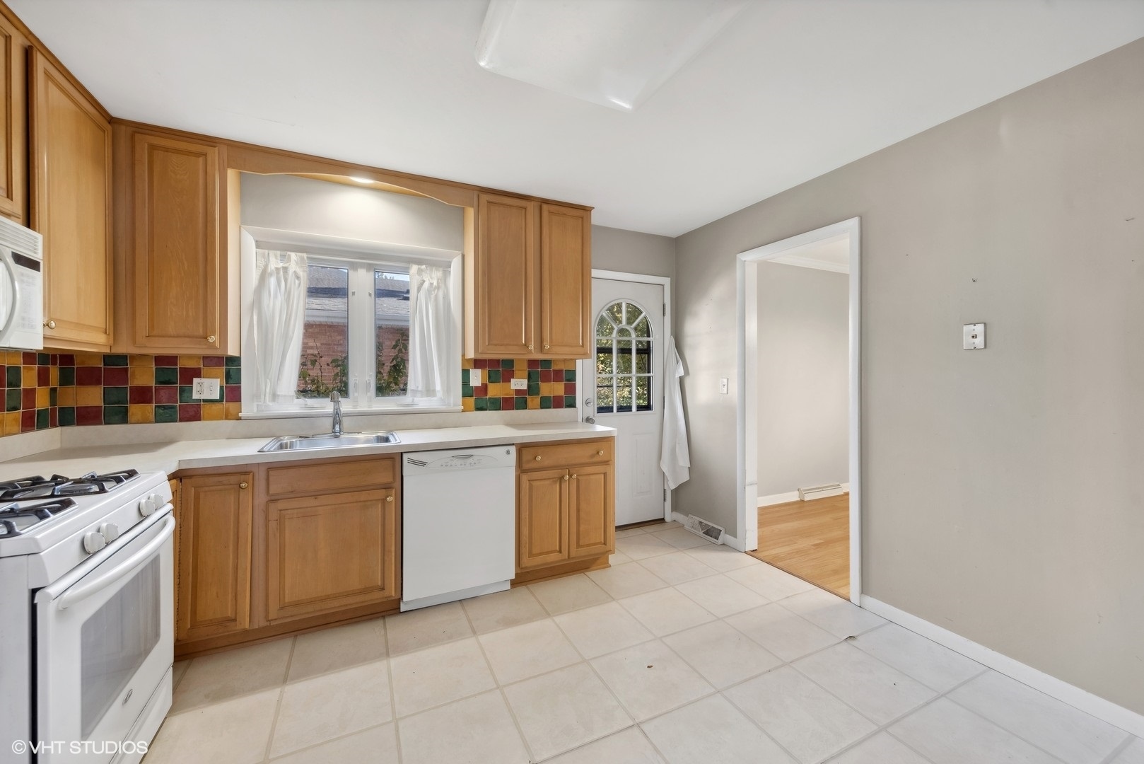 1521 Lakeside Drive Wheaton, IL 60187 - Photo 6 of 17 a large kitchen with a stove top oven sink and cabinets