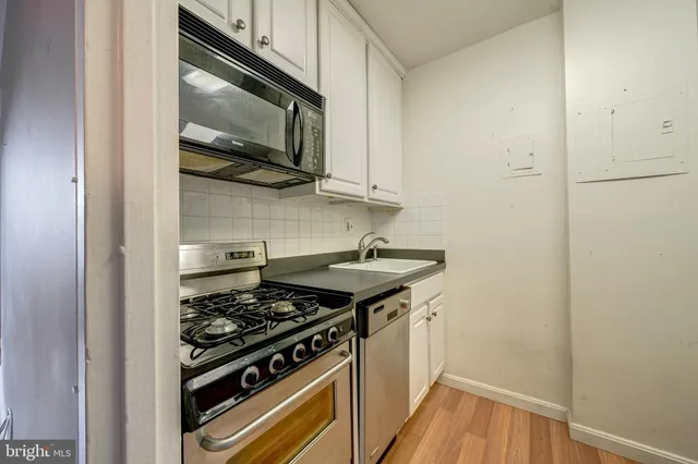 a kitchen with a stove and a microwave