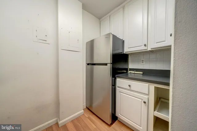 a kitchen with a refrigerator and cabinets