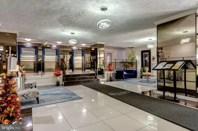 a lobby with furniture and stairs