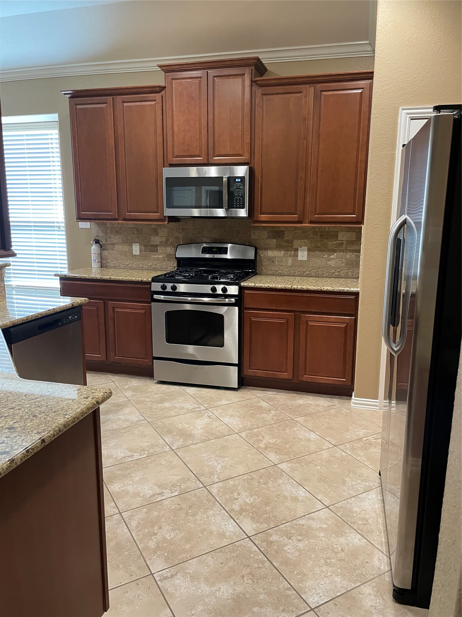 19518 Country Ranch Court Spring, TX 77388 - Photo 3 of 10 a kitchen with granite countertop a refrigerator and a sink