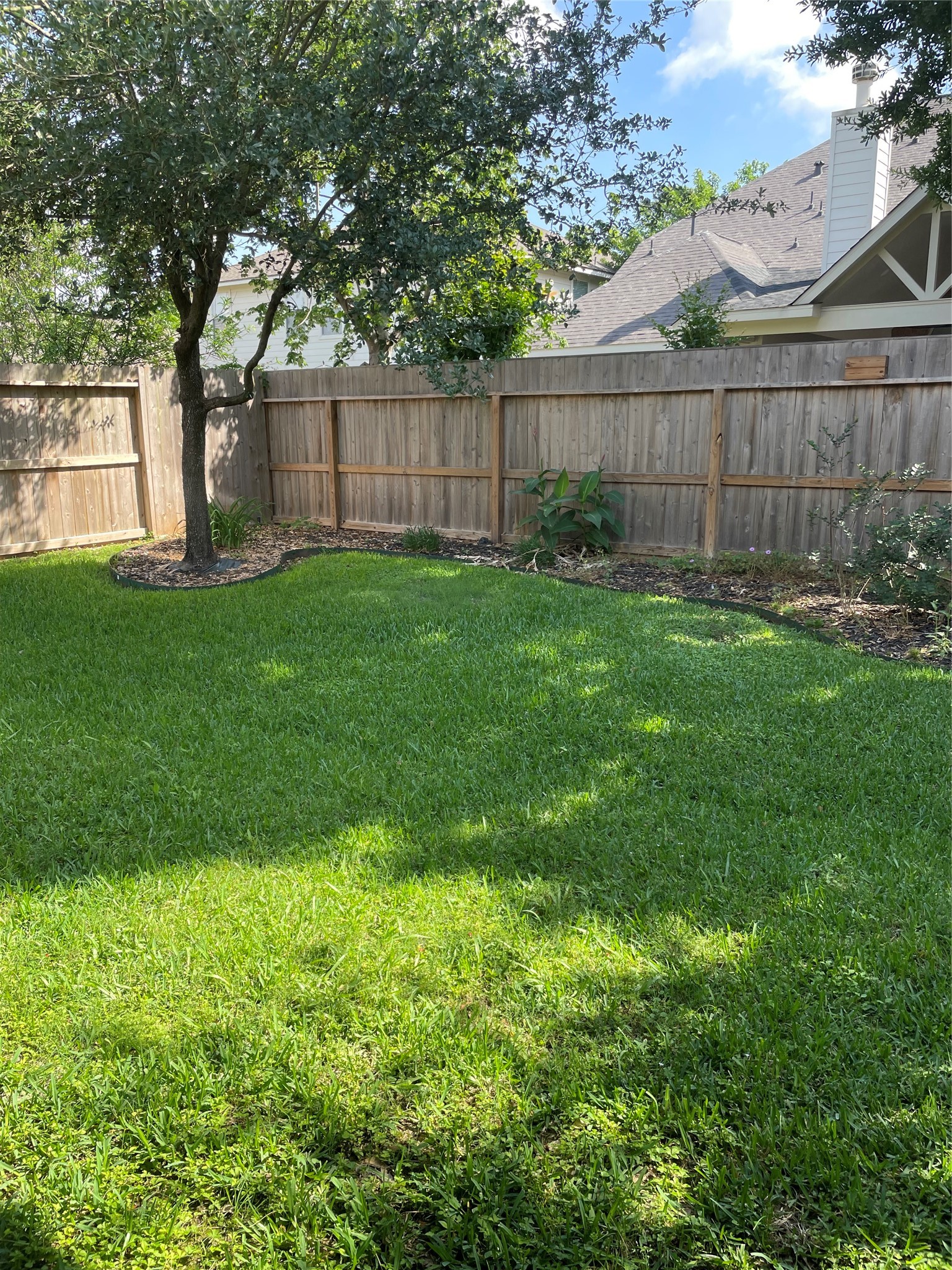 19518 Country Ranch Court Spring, TX 77388 - Photo 8 of 10 a view of a backyard with a large tree and wooden fence