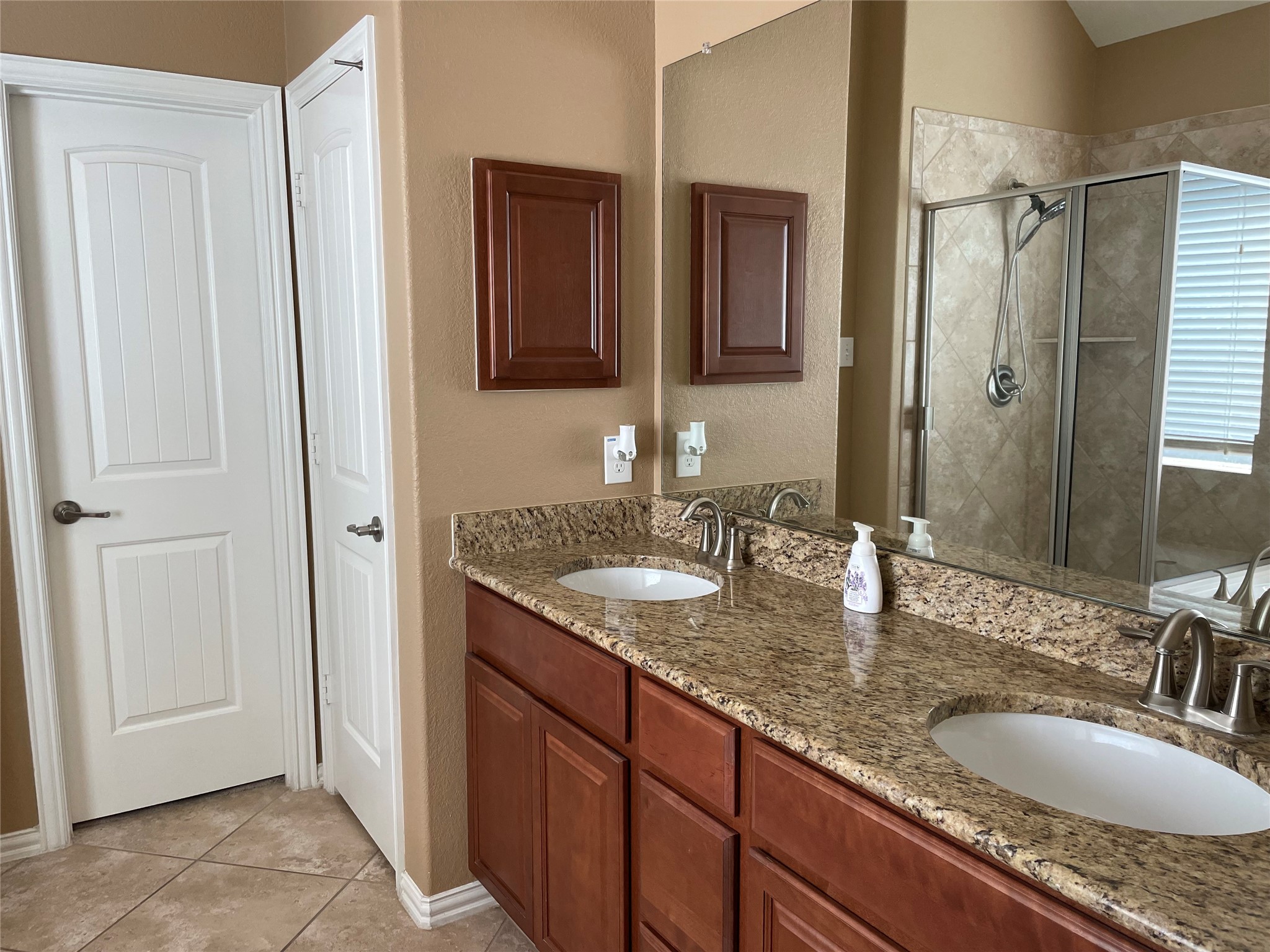 19518 Country Ranch Court Spring, TX 77388 - Photo 10 of 10 a bathroom with double granite countertop a sink and a mirror
