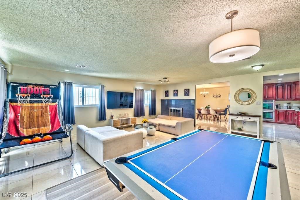 4990 Philmar Avenue Las Vegas, NV 89120 - Photo 13 of 32 Playroom featuring a textured ceiling and light tile patterned floors