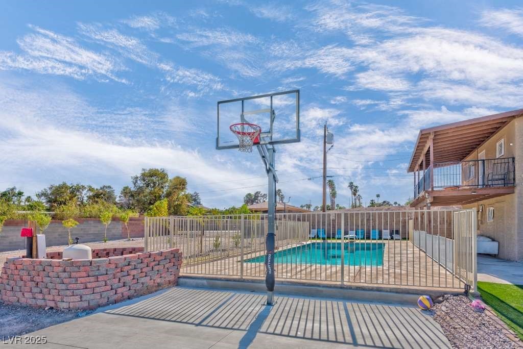 4990 Philmar Avenue Las Vegas, NV 89120 - Photo 2 of 32 View of basketball court with a patio area and a fenced backyard