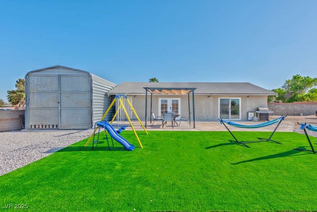 4990 Philmar Avenue Las Vegas, NV 89120 - Photo 24 of 32 Back of property featuring a patio area, a playground, and stucco siding