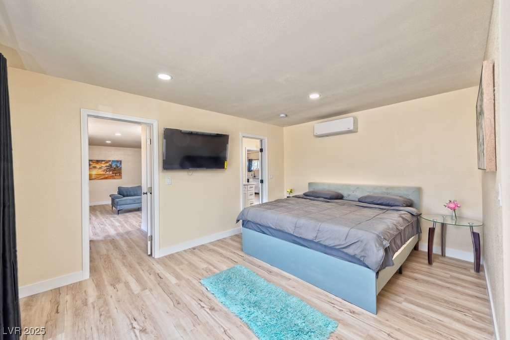 4990 Philmar Avenue Las Vegas, NV 89120 - Photo 26 of 32 Bedroom located in the casita with light wood finished floors, recessed lighting, and a wall mounted air conditioner
