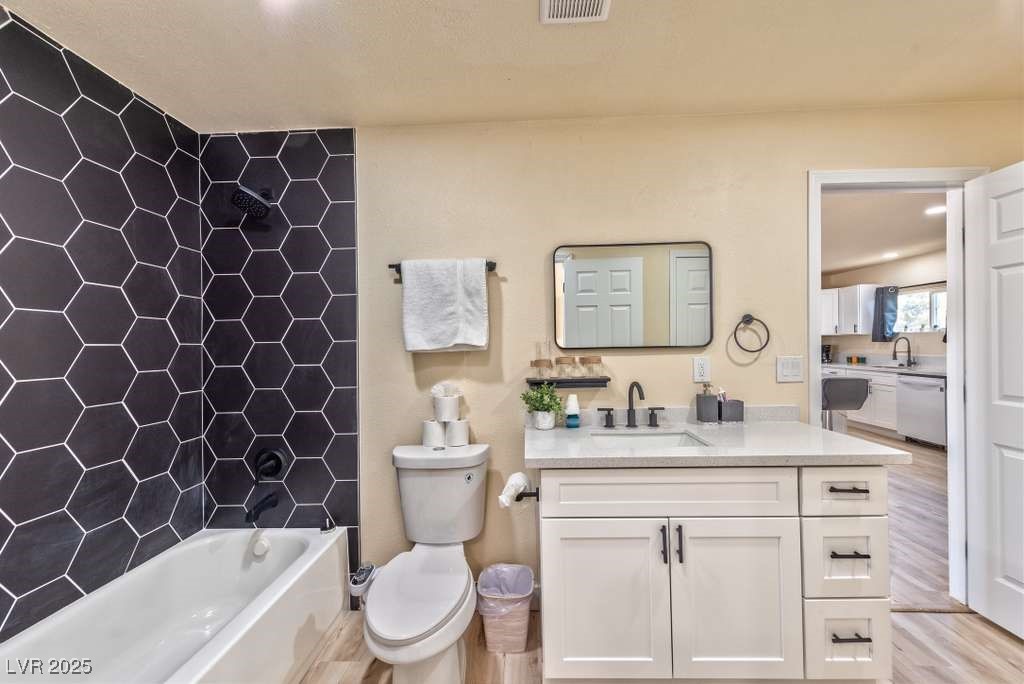 4990 Philmar Avenue Las Vegas, NV 89120 - Photo 28 of 32 Full bathroom featuring shower / bath combination, vanity, and light wood finished floors