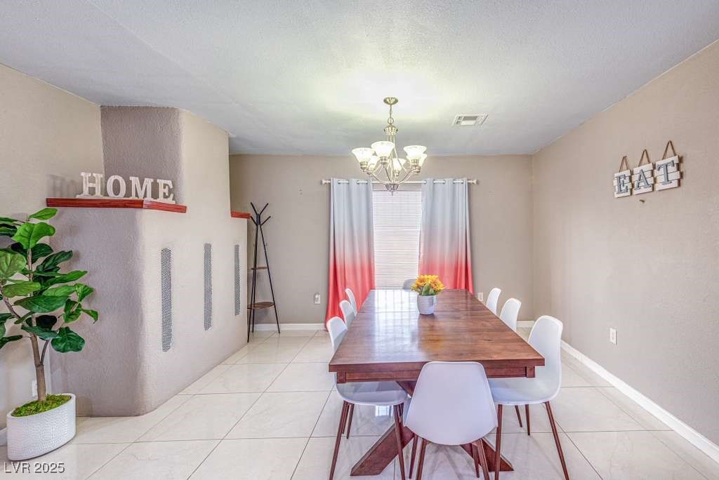 4990 Philmar Avenue Las Vegas, NV 89120 - Photo 6 of 32 Dining space featuring light tile patterned floors and a chandelier