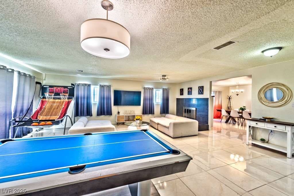 4990 Philmar Avenue Las Vegas, NV 89120 - Photo 9 of 32 Recreation room featuring a textured ceiling and tile patterned floors