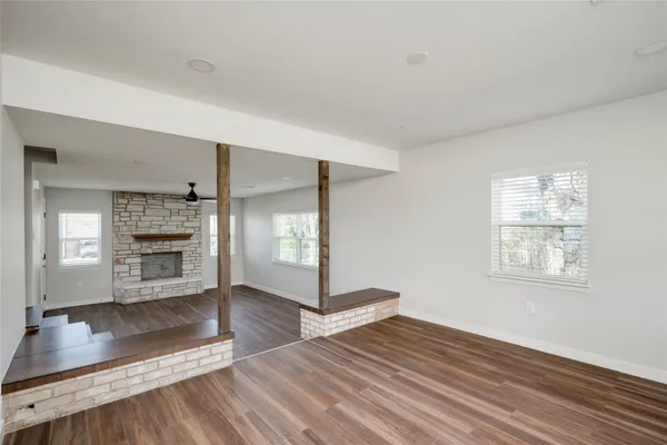 a view of a living room with hardwood floor and a ceiling fan