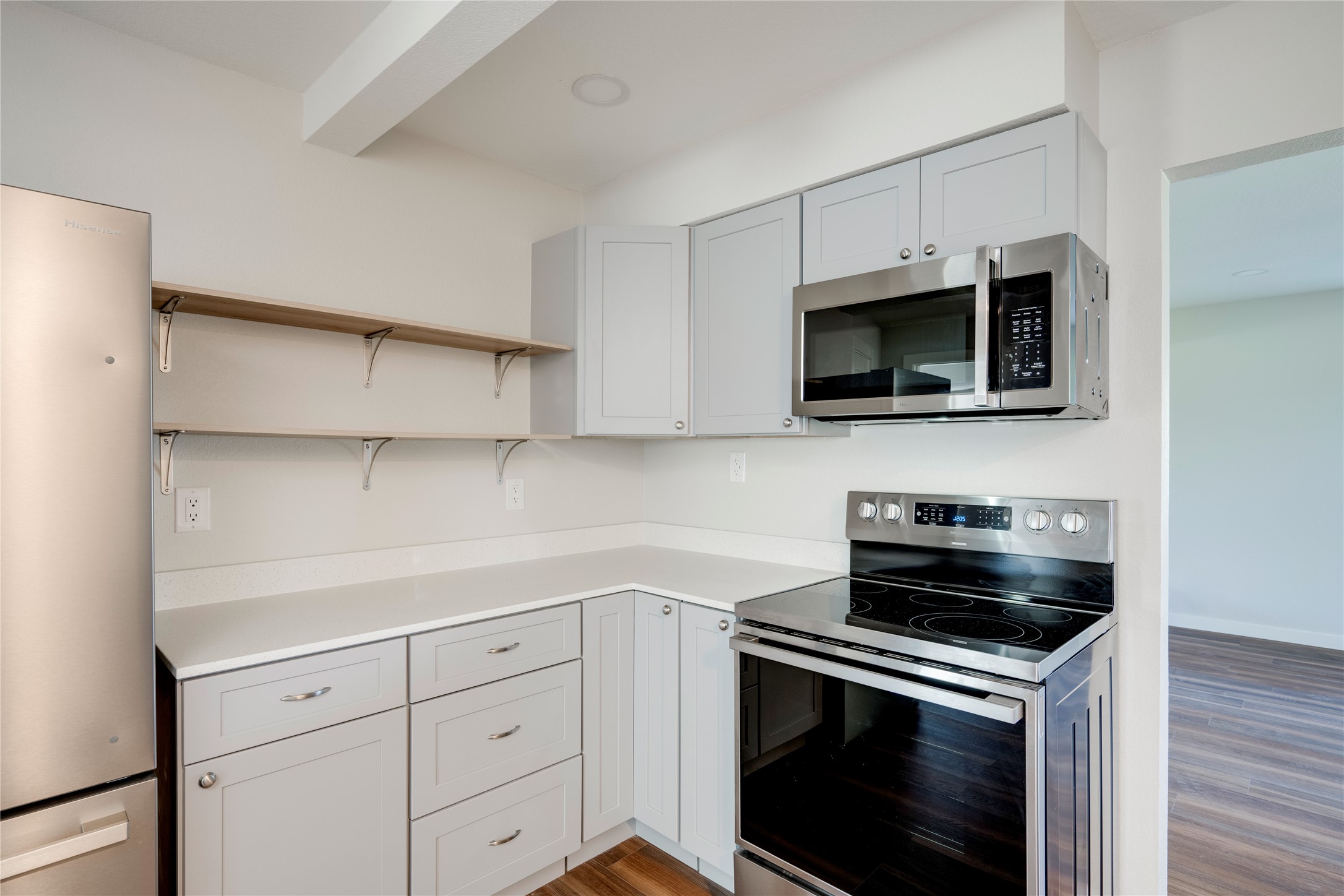809 North West Street Burnet, TX 78611 - Photo 20 of 40 a kitchen with cabinets stainless steel appliances and a wooden floor