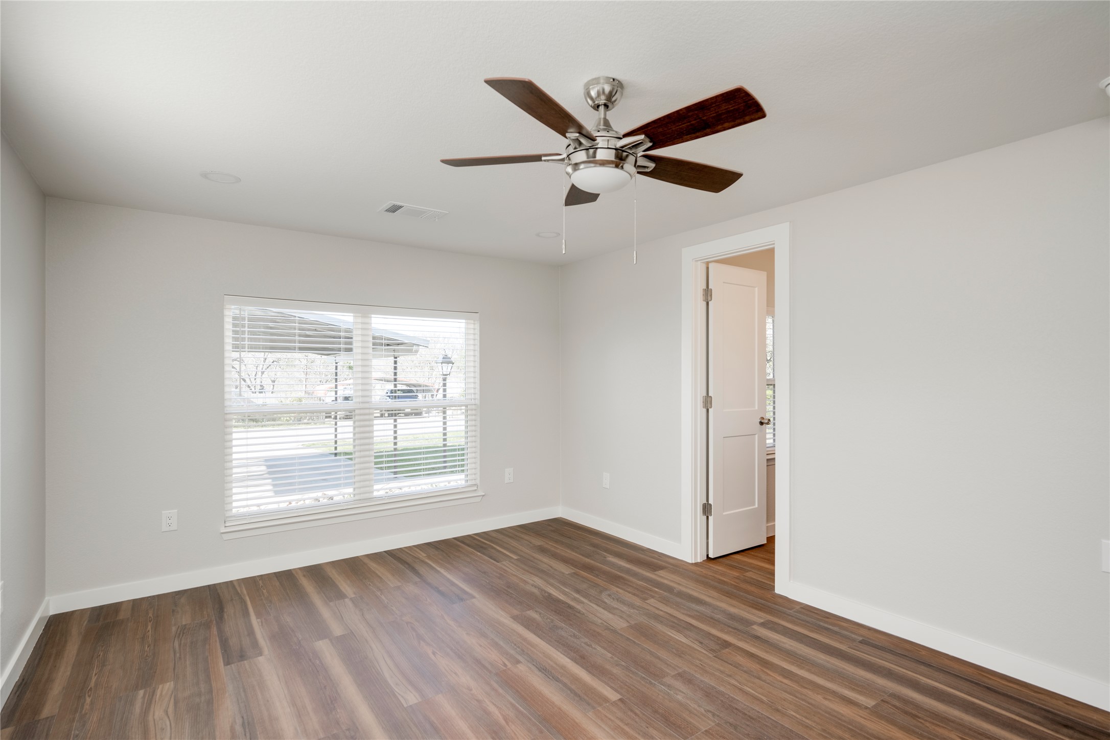 809 North West Street Burnet, TX 78611 - Photo 23 of 40 a view of an empty room with wooden floor and a window