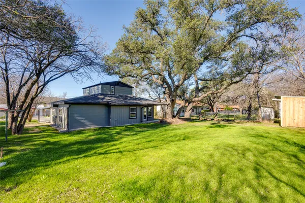 a view of a house with pool and trees