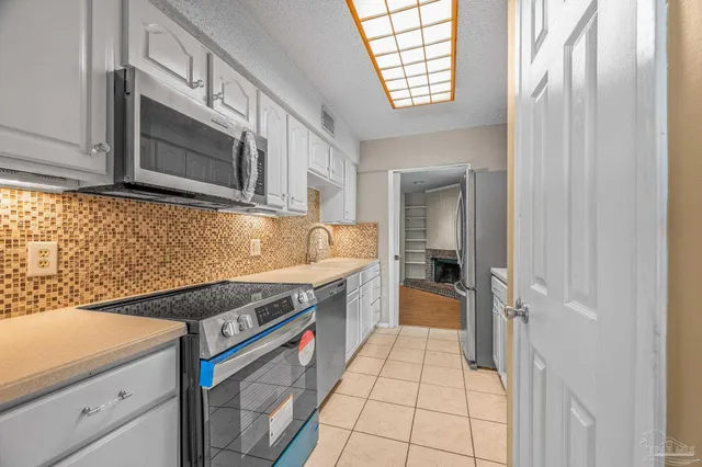 a kitchen with granite countertop a sink and a stove