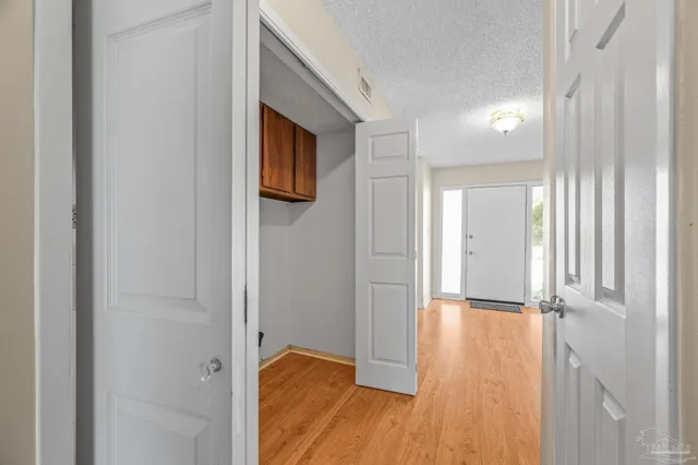 a view of a hallway with wooden floor