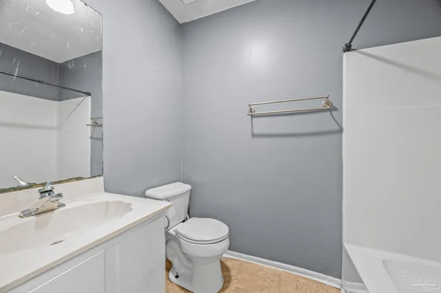 a bathroom with a sink a toilet and vanity