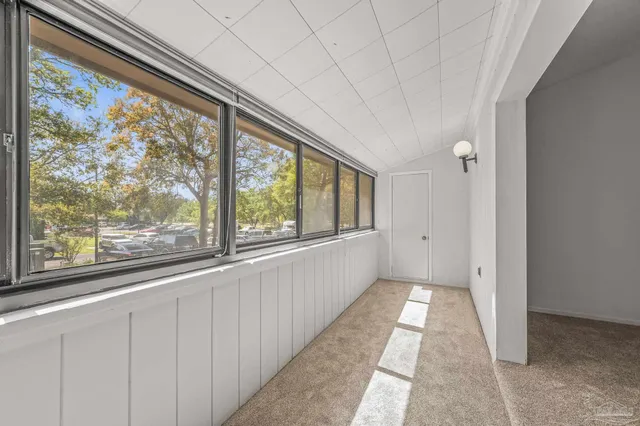 a big room with wooden floor and windows