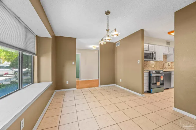 a view of a hallway with a chandelier