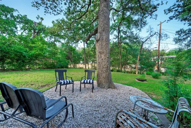 a view of a garden with furniture