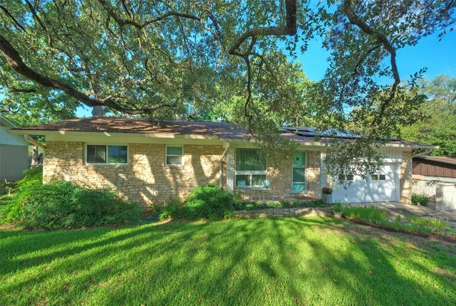 a view of a lake with a big yard and large trees