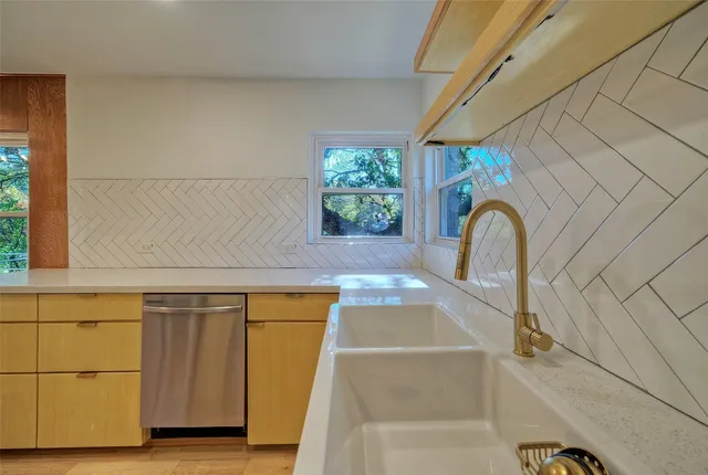 a bath tub sitting in a bathroom next to a window