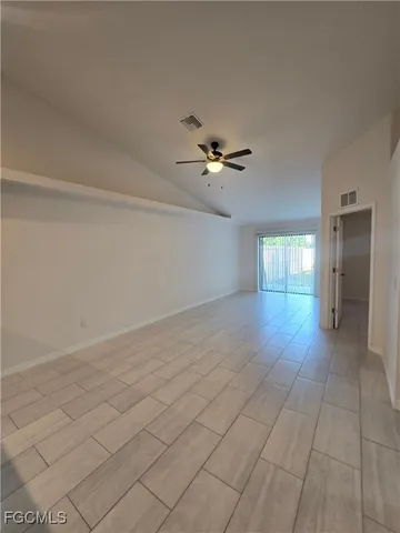 a view of a livingroom with a ceiling fan and window