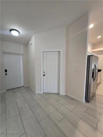 a kitchen with granite countertop a refrigerator and a sink