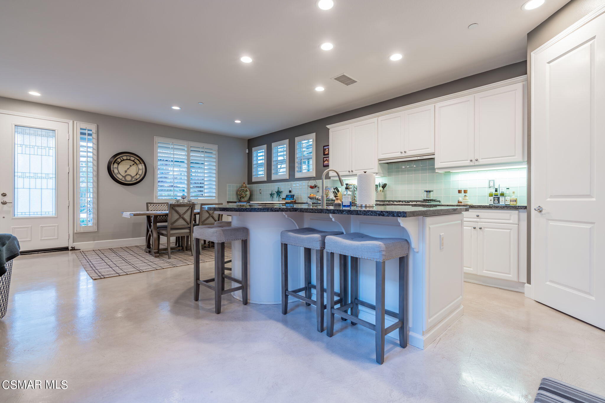 4064 Galapagos Way Oxnard, CA 93035 - Photo 9 of 55 a kitchen with cabinets and chairs